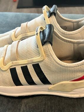 adidas Cream Slip-On Trainers with Black Stripes and Red Accent